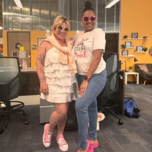 IVA High teacher, Ollie Cigliano, and another person pose together wearing pink shoes and sunglasses.